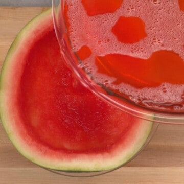 Pouring Watermelon Jello Mixture into Watermelon rind.