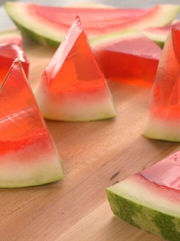 Watermelon Jello Shots made in the rind of a watermelon to look like real watermelon wedge.