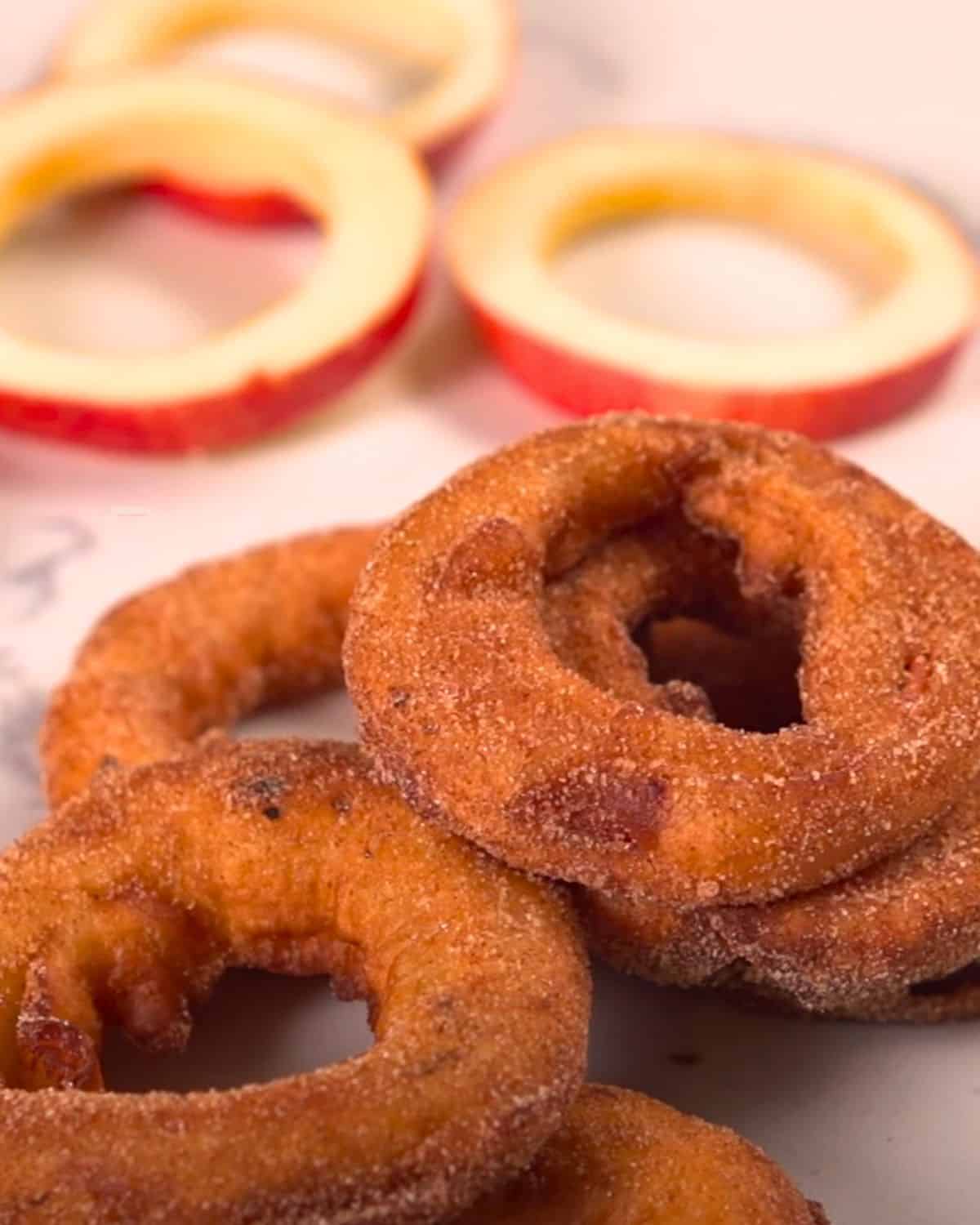 Apple cinnamon rings with apples in background.