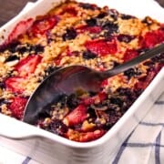 Baked Oatmeal in white casserole dish on linen.