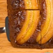Banana fosters upside down cake on cutting board.