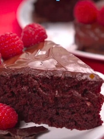 Crazy chocolate cake plated with raspberries.