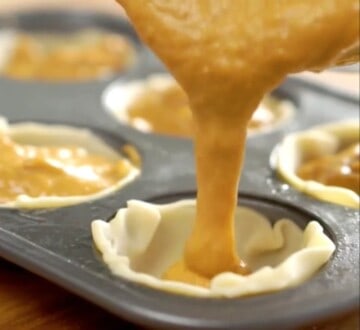 Pouring pumpkin pie batter into muffin tin.